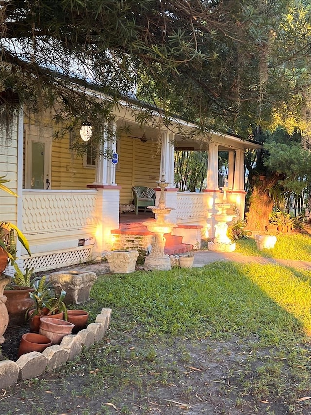 view of yard featuring covered porch