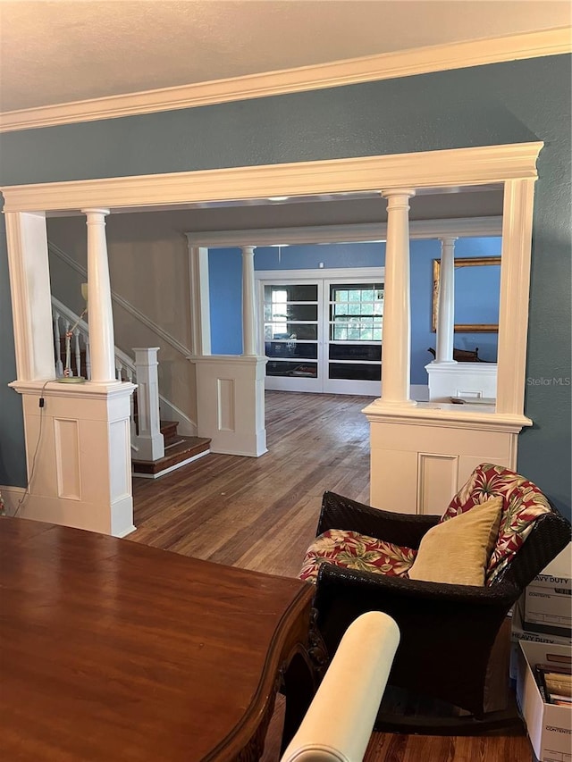 living room with hardwood / wood-style flooring and ornamental molding