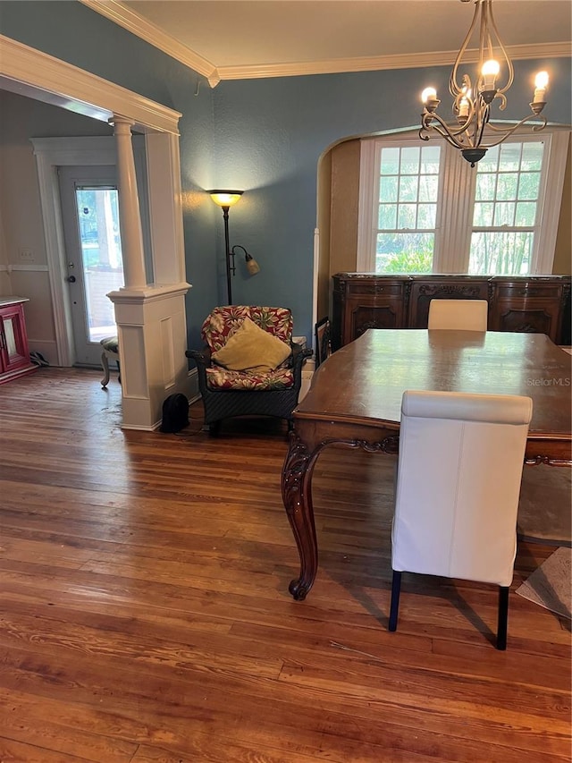 dining space featuring a chandelier, crown molding, and dark wood-type flooring