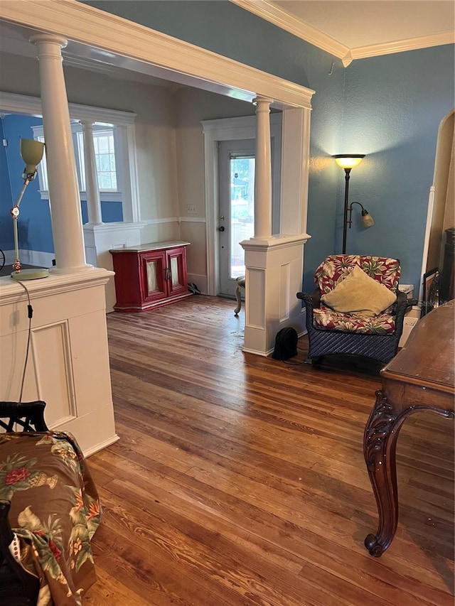 sitting room featuring crown molding, a wealth of natural light, and dark wood-type flooring