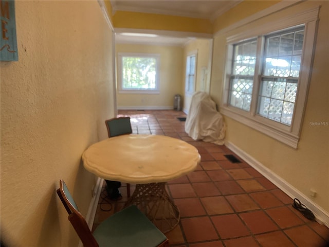 dining room featuring tile patterned floors and ornamental molding