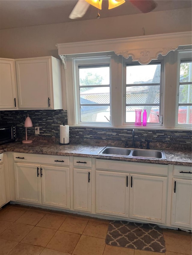 kitchen featuring decorative backsplash, plenty of natural light, and sink