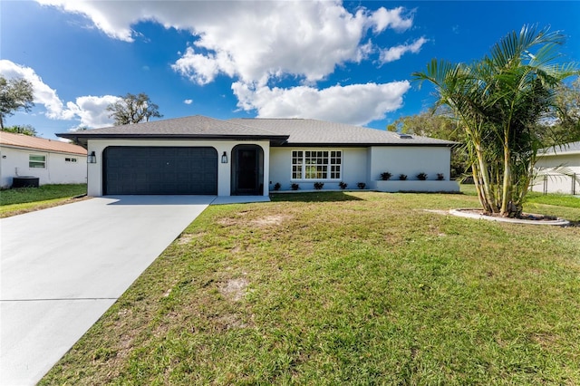 ranch-style home featuring a front lawn and a garage