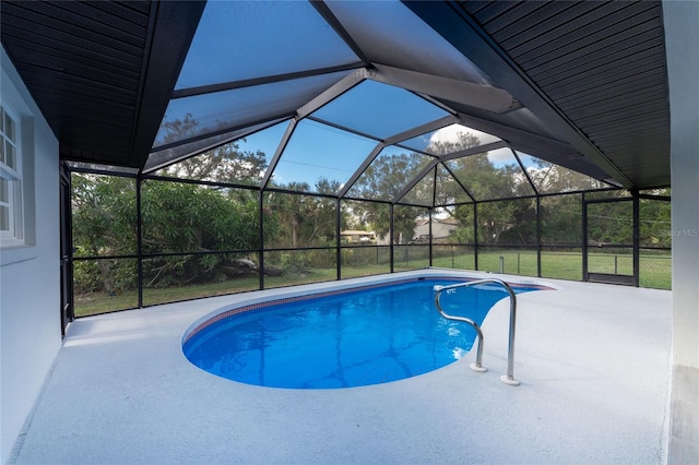 view of pool featuring a lanai, a patio area, and a lawn