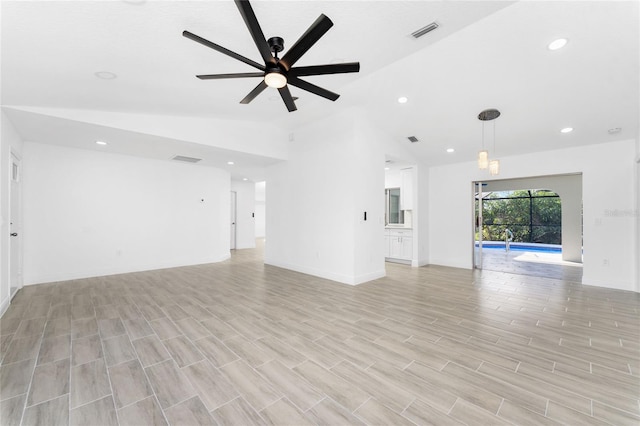 unfurnished living room featuring light hardwood / wood-style flooring, ceiling fan, and lofted ceiling