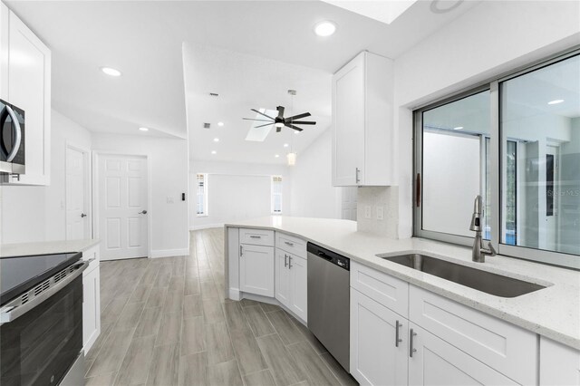 kitchen with white cabinetry, sink, ceiling fan, and appliances with stainless steel finishes