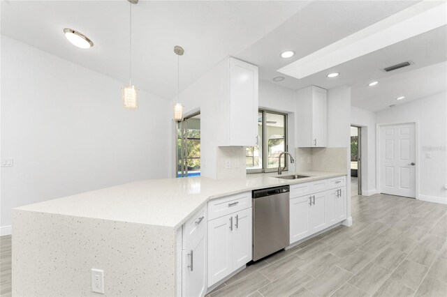 kitchen with white cabinetry, sink, pendant lighting, kitchen peninsula, and dishwasher