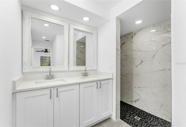 bathroom featuring vanity, a tile shower, ceiling fan, and hardwood / wood-style flooring