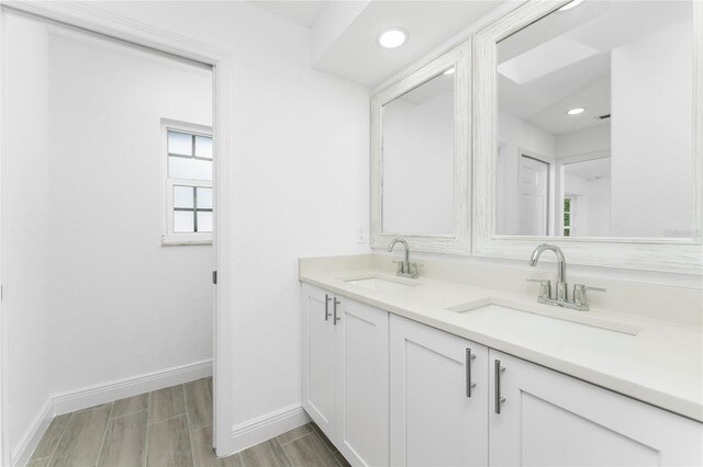 bathroom with hardwood / wood-style floors and vanity