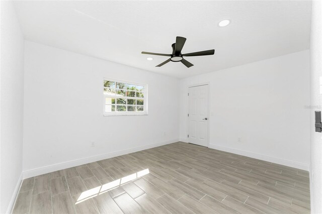 spare room featuring ceiling fan and light hardwood / wood-style floors