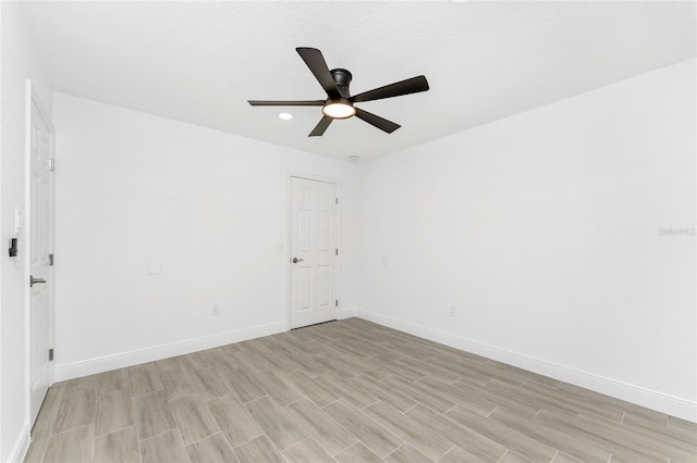 spare room featuring light wood-type flooring and ceiling fan