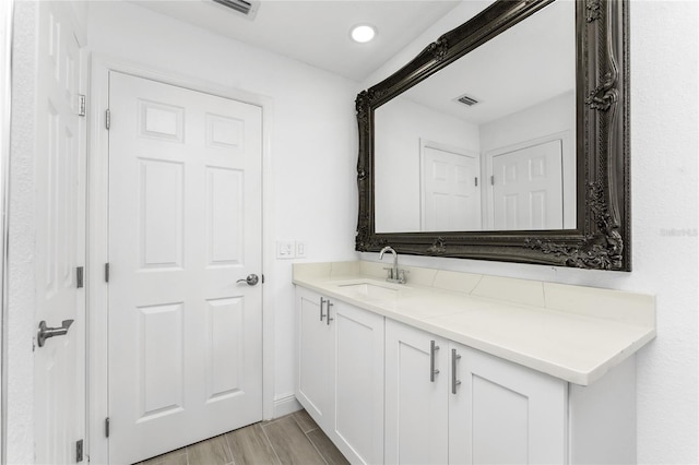 bathroom with vanity and hardwood / wood-style floors