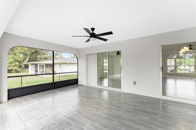 unfurnished sunroom with ceiling fan