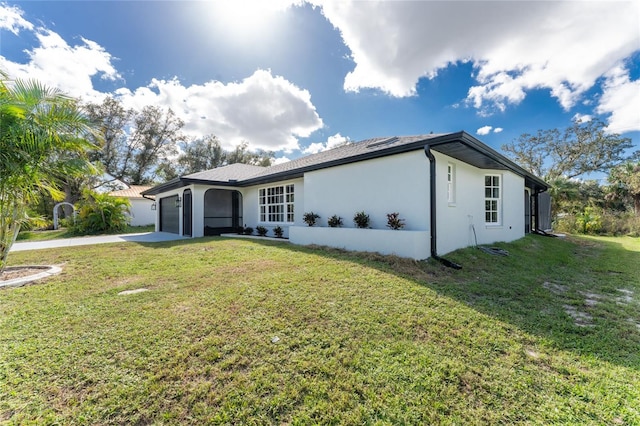 single story home featuring a front yard and a garage