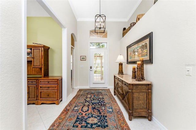 tiled foyer entrance featuring crown molding