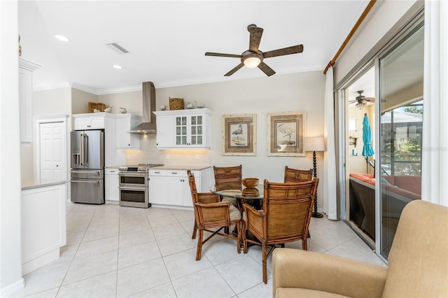 dining area with ceiling fan, light tile patterned flooring, and ornamental molding