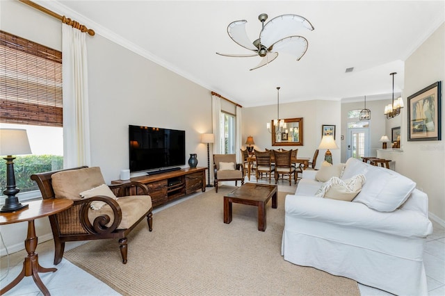 tiled living room with a chandelier, french doors, and crown molding