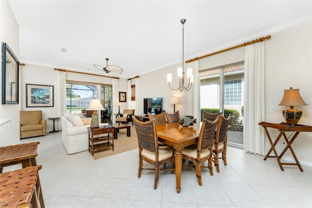 dining space with light tile patterned floors, ceiling fan with notable chandelier, and crown molding