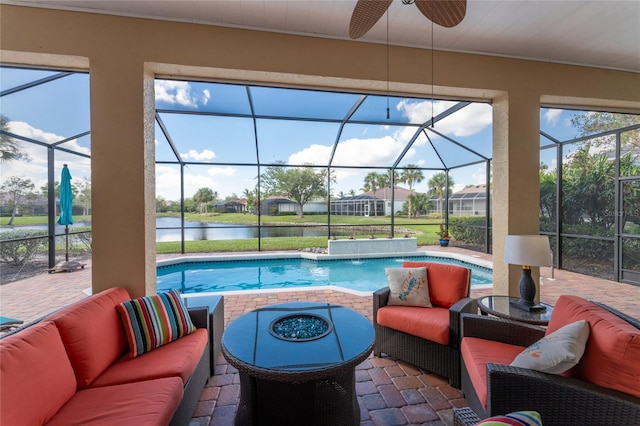 view of pool with an outdoor living space, a water view, and a patio area