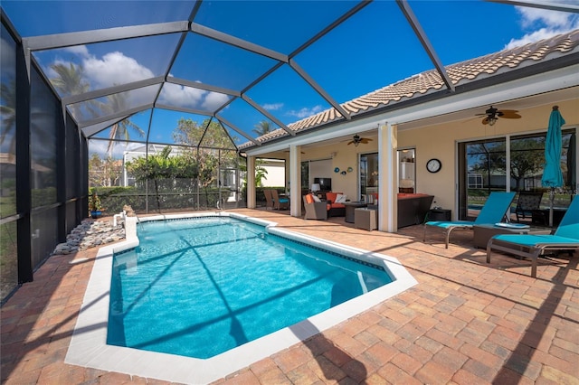 view of swimming pool featuring outdoor lounge area, a lanai, ceiling fan, and a patio area