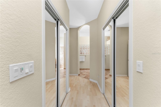 corridor with light hardwood / wood-style floors