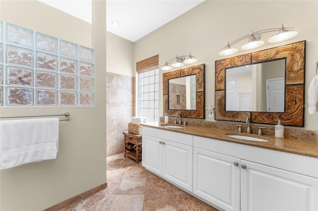 bathroom featuring vanity and tile walls