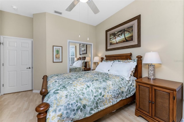 bedroom with ceiling fan, a closet, and light wood-type flooring