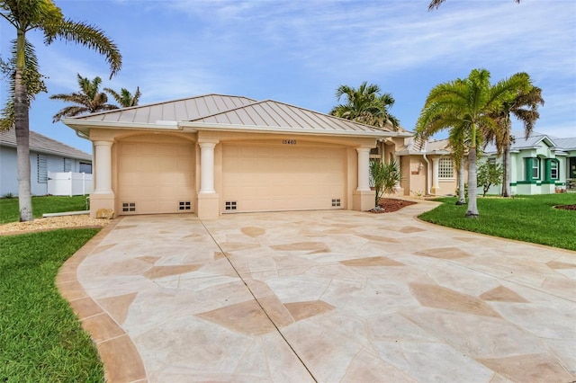 15460 Longview Rd, Port Charlotte, FL 33981 - ranch-style house with a standing seam roof, driveway, a front lawn, stucco siding, and an attached garage