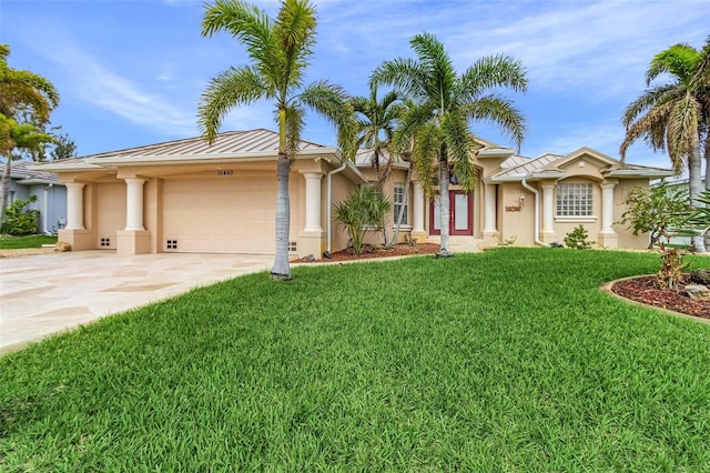 15460 Longview Rd, Port Charlotte, FL 33981 - ranch-style house featuring a garage, stucco siding, driveway, a front lawn, and a standing seam roof