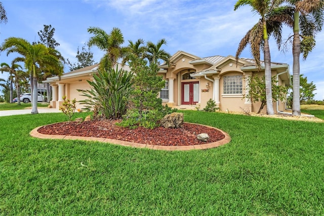 15460 Longview Rd, Port Charlotte, FL 33981 - view of front of house featuring stucco siding, french doors, a garage, a front yard, and driveway