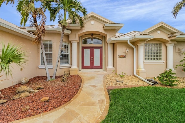 15460 Longview Rd, Port Charlotte, FL 33981 - view of exterior entry featuring stucco siding and french doors