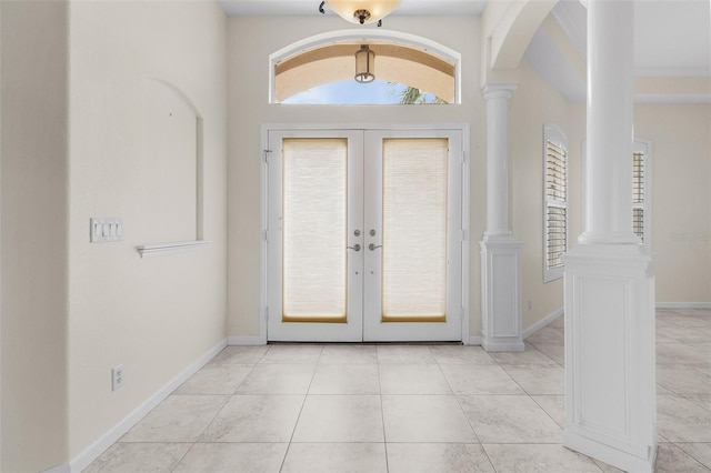 15460 Longview Rd, Port Charlotte, FL 33981 - foyer featuring arched walkways, french doors, ornate columns, and light tile patterned floors