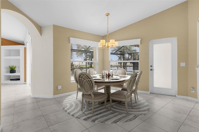 dining room featuring built in features, light tile patterned floors, an inviting chandelier, and vaulted ceiling