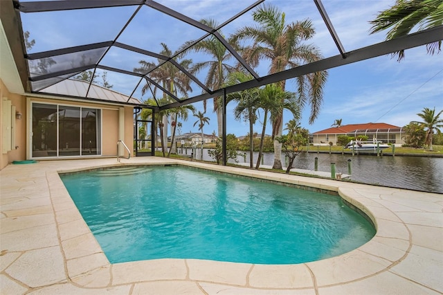 view of pool featuring glass enclosure, a dock, a water view, and a patio