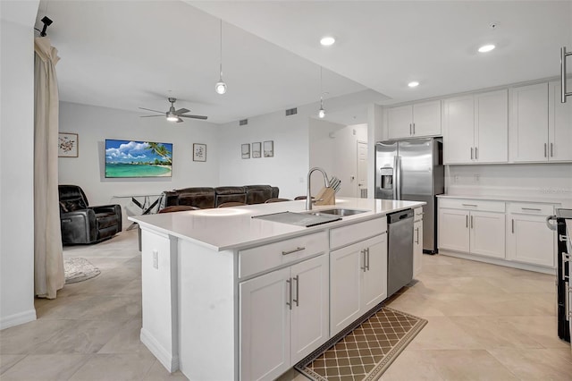 kitchen featuring appliances with stainless steel finishes, ceiling fan, a kitchen island with sink, sink, and white cabinetry