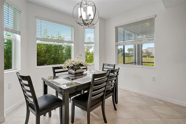 tiled dining room with a healthy amount of sunlight and an inviting chandelier