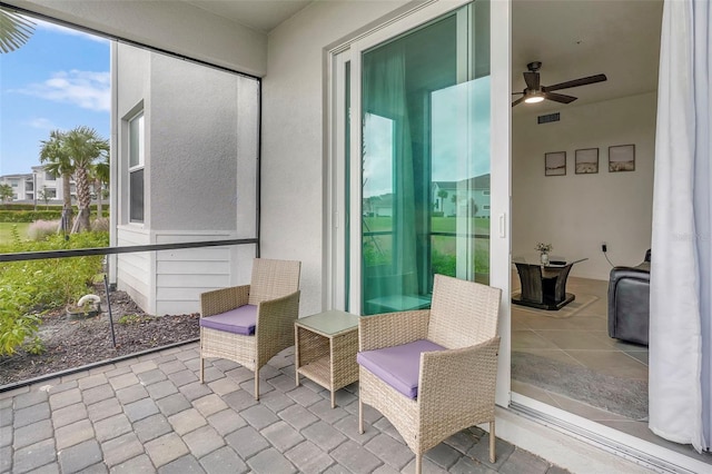 sunroom / solarium with a wealth of natural light and ceiling fan