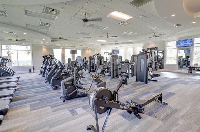 gym featuring a paneled ceiling and light carpet