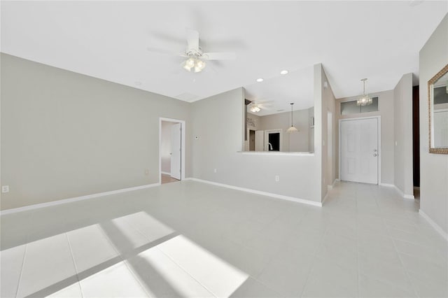 unfurnished living room with light tile patterned flooring and ceiling fan with notable chandelier