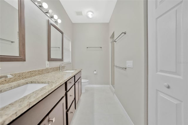 bathroom with vanity, toilet, and an enclosed shower