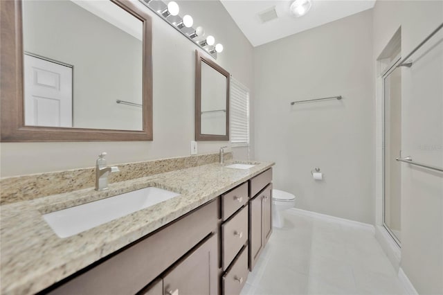 bathroom with toilet, vanity, tile patterned floors, and a shower with shower door