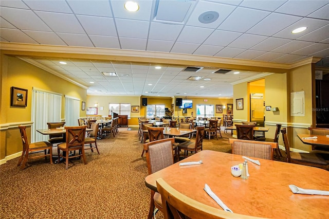 dining area featuring a paneled ceiling, carpet flooring, and crown molding