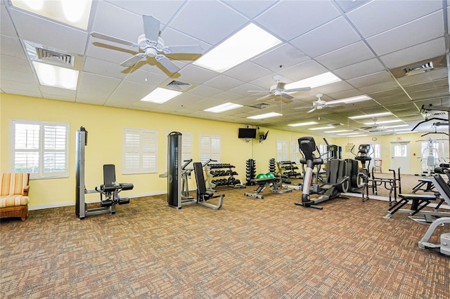 gym with a drop ceiling and carpet