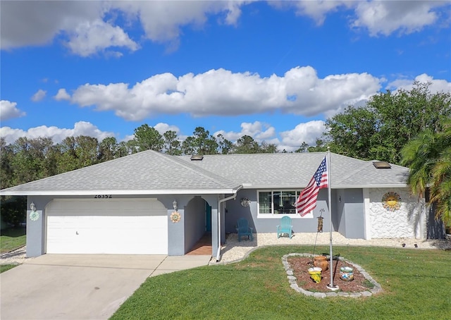 26352 Copiapo Cir, Punta Gorda, FL 33983 - single story home with a garage, roof with shingles, a front yard, stucco siding, and concrete driveway