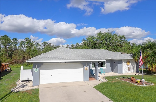 single story home with a garage and a front lawn