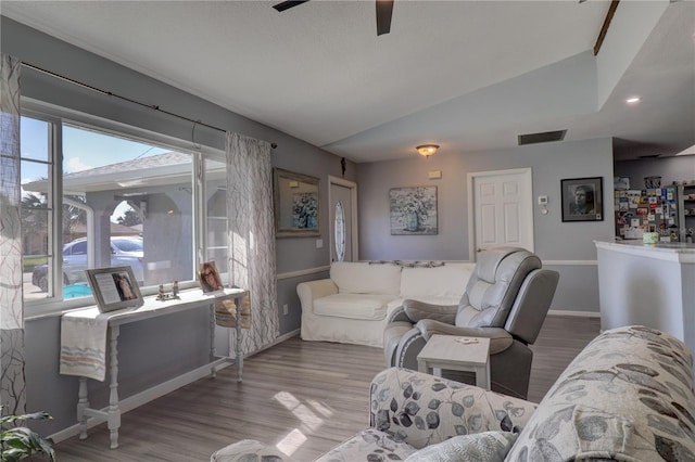 living room featuring hardwood / wood-style flooring, ceiling fan, and lofted ceiling