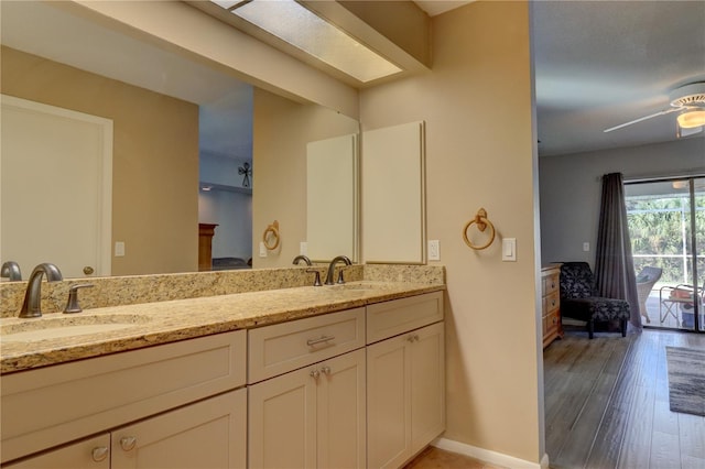 bathroom with vanity, hardwood / wood-style floors, and ceiling fan