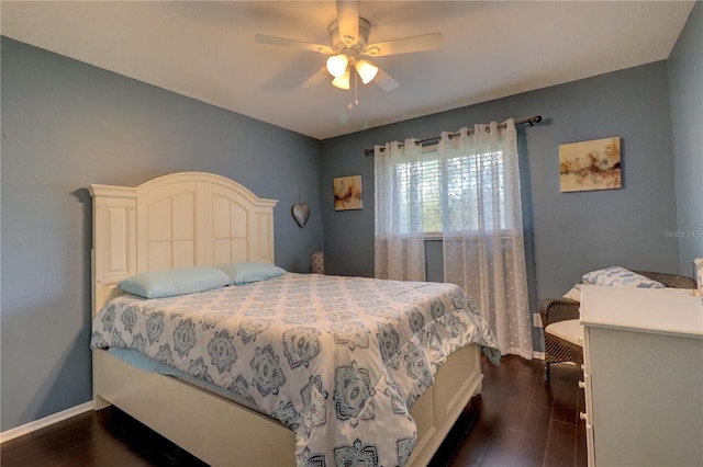 bedroom with dark hardwood / wood-style floors and ceiling fan