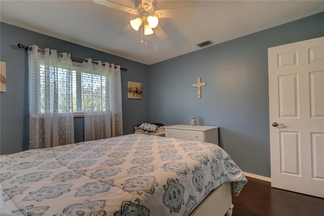 bedroom featuring ceiling fan and dark hardwood / wood-style flooring