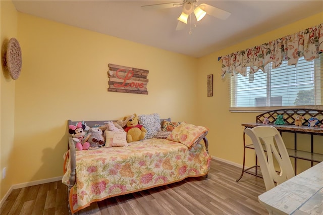 bedroom featuring hardwood / wood-style flooring and ceiling fan